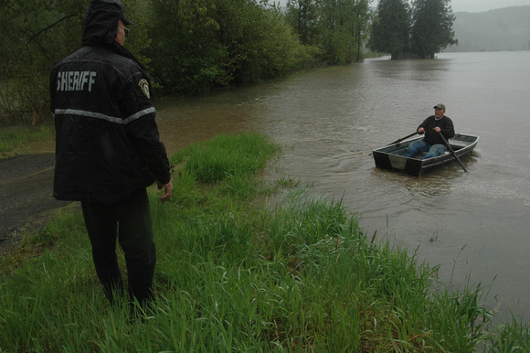 As they wait for the marine patrol, Benewah County Sheriff Bob Kirts tries to dissuade a neighbor from going solo to check on an eldery St. Joe River resident during a spring flood